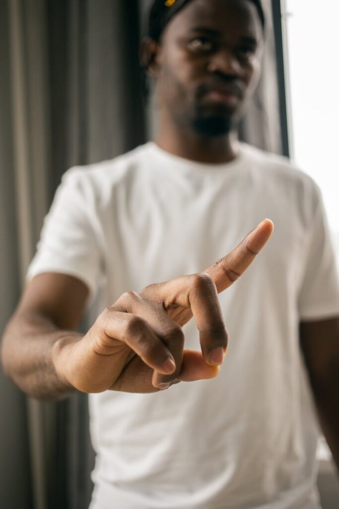 serious black man showing stop gesture with index finger