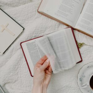 person holding white book page